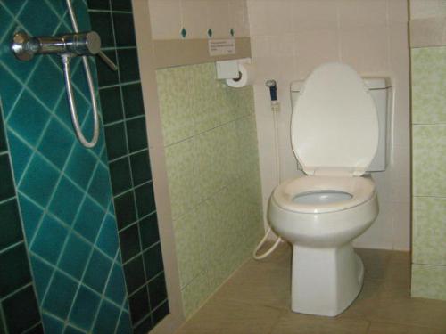 a bathroom with a white toilet in a stall at Lamoon Lamai Residence & Guesthouse in Lamai