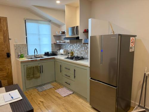 una cocina con refrigerador de acero inoxidable en Studio Apartment in Port Barton, en San Vicente