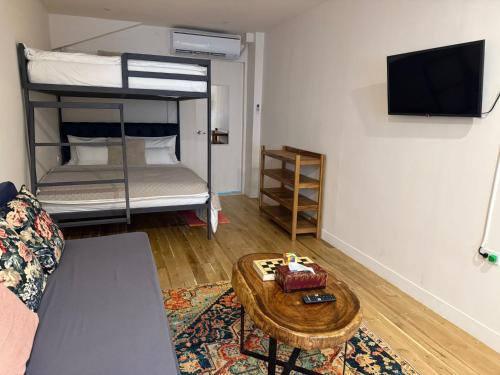 a living room with a couch and a table with a cake at Studio Apartment in Port Barton in San Vicente