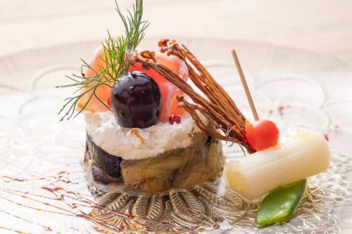 a piece of food on a plate with fruit on it at Private Japanese Modern Onsen Villa Azumino Salon1 in Azumino