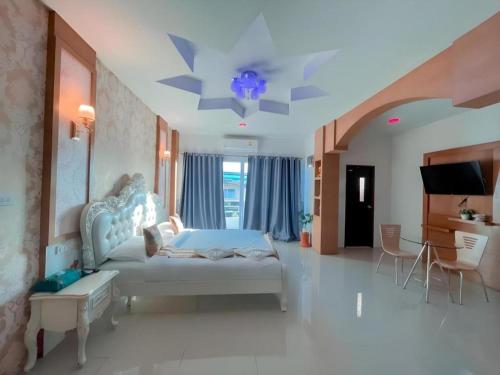 a bedroom with a bed and a tv in it at The Linux Garden Hotel (City Amphur Muang Yala) in Yala