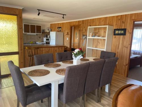 a dining room and kitchen with a table and chairs at 41 Bailey Rd - Family - Surf Beach - No Linen Included in Middleton