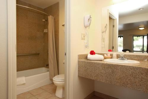 a bathroom with a sink and a toilet and a shower at Monterey Oceanside Inn in Monterey