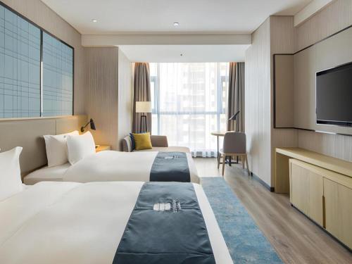 Ένα ή περισσότερα κρεβάτια σε δωμάτιο στο Echarm Hotel Changsha Gaoqiao