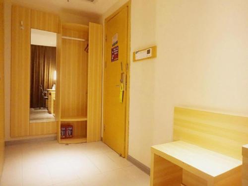 a room with a hallway with a yellow door at City Comfort Inn Zhanjiang Middle Renmin Avenue Dingsheng Square in Zhanjiang