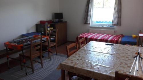 a living room with a table and a dining room at Penzion Kabourek in Vítkovice
