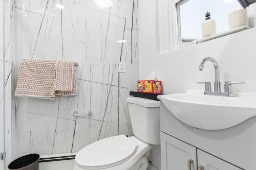 a bathroom with a toilet and a sink and a shower at Hamilton in Harrison