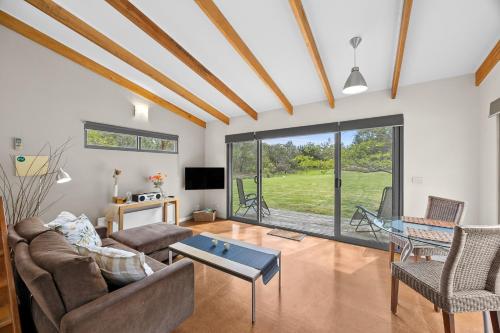 a living room with a couch and a table at Bellbrae Harvest in Torquay