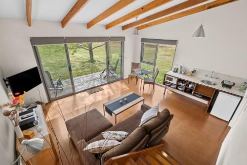 a living room with a couch and a table at Bellbrae Harvest in Torquay