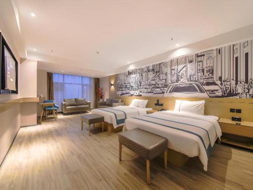 a hotel room with two beds and a television at City Comfort Inn Shiyan High-speed Railway Wanda Plaza in Shiyan