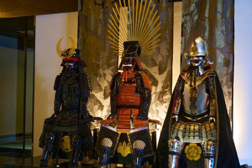 two statues of armor on display in a window at Espacio Nagoya Castle, The Leading Hotels of the World "LHW" in Nagoya