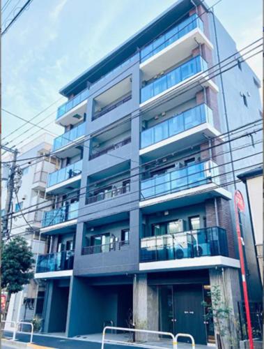 an apartment building with balconies on the side of it at Dash Living Osaki in Tokyo