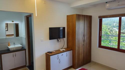 TV a/nebo společenská místnost v ubytování Coral Inn Residency