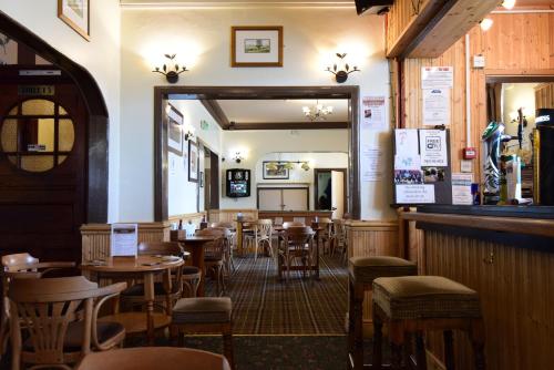 a restaurant with tables and chairs and a mirror at The Black Bull inn in Wooler