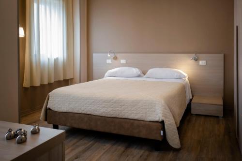 a bedroom with a large bed and a window at Magic Hotel in Atena Lucana