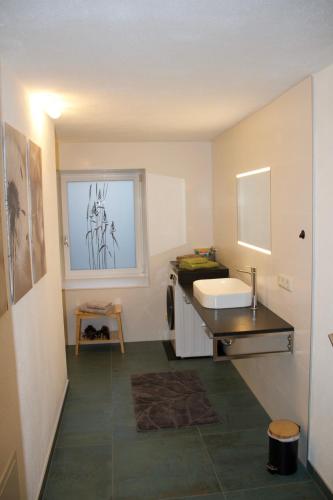 a small bathroom with a sink and a counter at Ferienwohnung Märzinger in Ulrichsberg