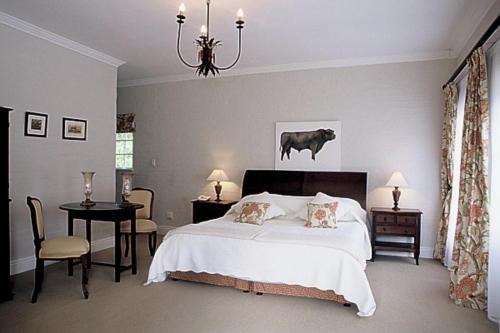 a bedroom with a bed with a cow on the wall at Fordoun Hotel and Spa in Nottingham Road