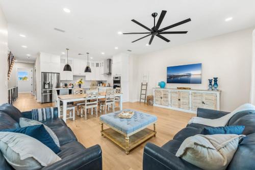 a living room with two blue couches and a kitchen at 40 8th Avenue in Indialantic
