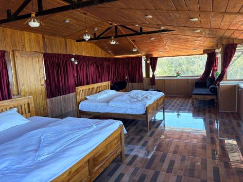 a bedroom with two beds in a room at 11 Haven Street Kodaikanal in Kodaikānāl