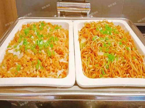 two trays of food sitting on a table at Hanting Hotel Beijing Daxing Caiyu in Beijing