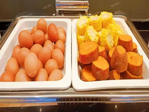 two trays of eggs and other food on a refrigerator at Hanting Hotel Beijing Daxing Caiyu in Beijing