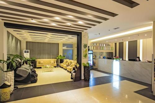 a lobby with a waiting area with a couch at Eighty Eight Hotel in Koronadal
