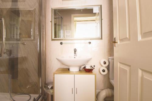 a bathroom with a sink and a shower at The Black Bull inn in Wooler