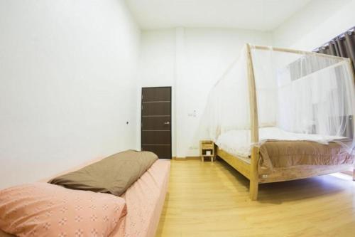 a bedroom with two beds and a swing at Maximize Brand New Hostel Udonthani in Udon Thani