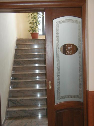 a staircase leading up to a room with a door at Hotel San Giorgio in San Nicola Arcella