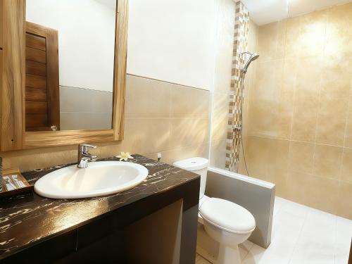 a bathroom with a sink and a toilet at Blue Opal Hotel in Amed