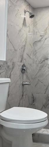a bathroom with a shower with a toilet and a sink at 2chambres salon villa Thierno sene in Niakoul Rap
