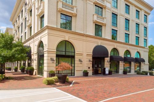 a building on a street in front of a building at The Hamilton Alpharetta, Curio Collection By Hilton in Alpharetta