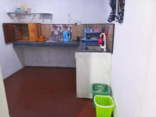 a small kitchen with a sink and a basket at CYT VILLA - Ja Ela in Ja-Ela