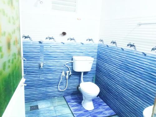 a bathroom with a toilet and horses on the wall at CYT VILLA - Ja Ela in Ja-Ela