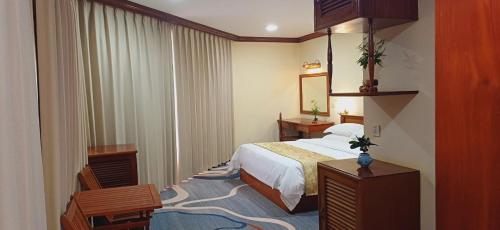 a hotel room with a bed and a mirror at Domi Hotel in Siem Reap