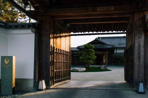 an entrance to a building with a gate and a tree at Shisui, a Luxury Collection Hotel, Nara in Nara