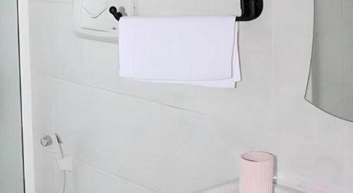 a white bathroom with a mirror and a sink at The MGS Hotel in Kadirandola