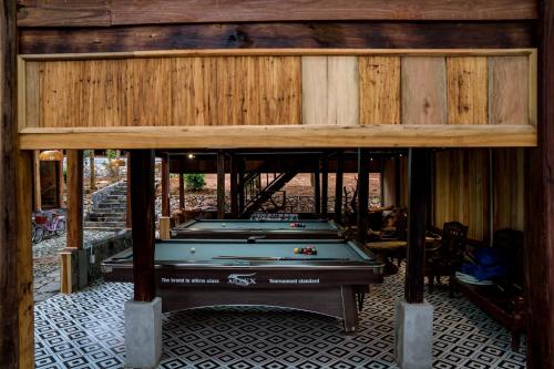 a pool table in the middle of a house at Balana HaGiang in Làng Lap
