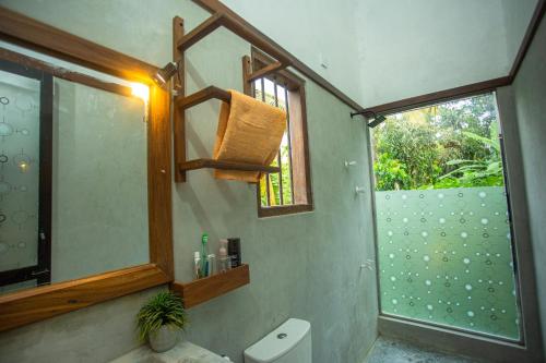 a bathroom with a sink and a window and a toilet at Amora Villa in Galle