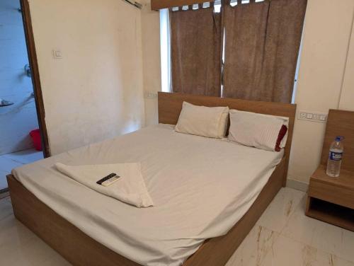 Ένα ή περισσότερα κρεβάτια σε δωμάτιο στο Collection O Dattapukur Railway Terminal Kolkata