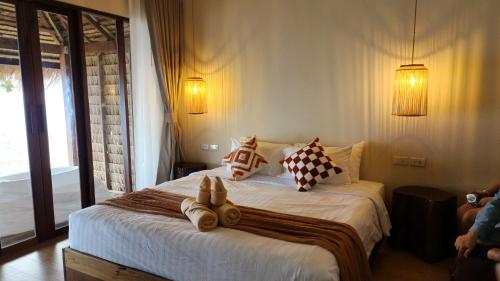 Postel nebo postele na pokoji v ubytování Sunstone Koh Chang