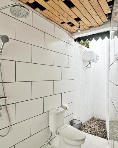 a bathroom with a toilet and a shower at The Amrta Borobudur in Borobudur
