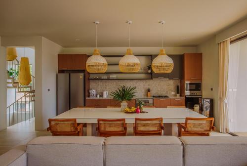 a kitchen with a large white table and chairs at Treetop Bliss Villa by Sea N' Rent in Koh Phangan