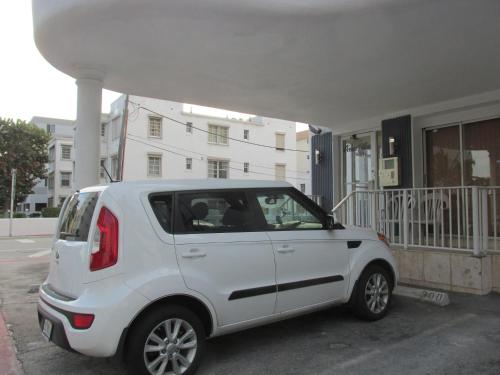 a white car parked in front of a building at Ocean Breeze in Miami Beach
