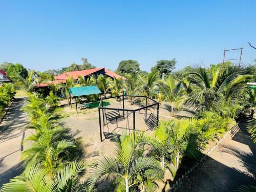 an aerial view of a resort with palm trees at Rama Hills Unity Resort in Kevadia