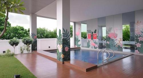 a room with a swimming pool in a house at Horison Nindya Semarang in Alastuwo