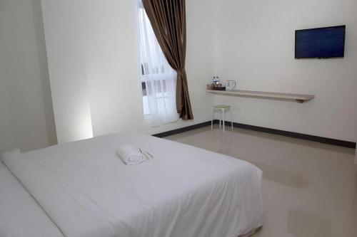 Ένα ή περισσότερα κρεβάτια σε δωμάτιο στο Sakura Manado