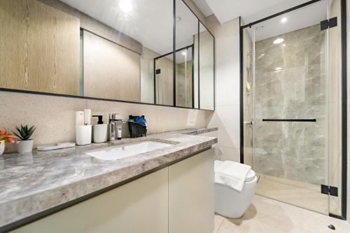 a bathroom with a sink and a shower at ALiving Elegant 1BR I Golf Gate, DAMAC Hills in Dubai