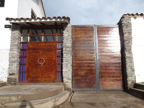 a wooden gate in front of a building at La Cabaña Hotel in Cusco