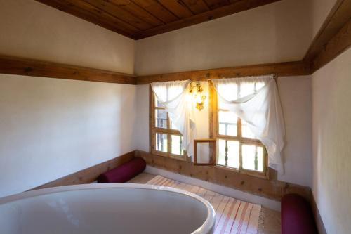 a bath tub in a room with a window at Gulevi Safranbolu Heritage Hotel in Safranbolu